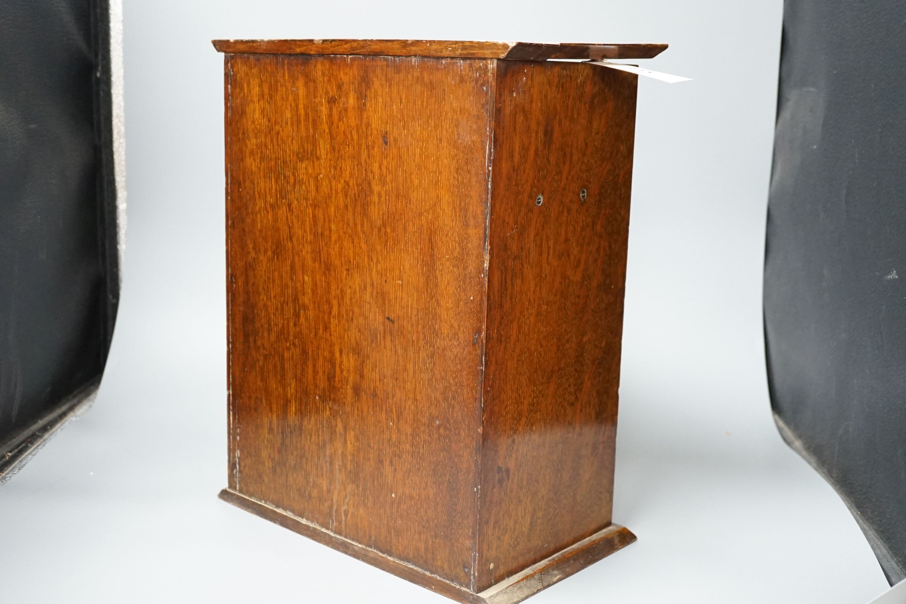 A late Victorian smokers cabinet with embossed metal panel to door and fitted interior 40cm